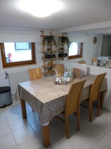 a dining room table with chairs and a table cloth at Ferienwohnung Jansen "Eins" in Bad Schwalbach