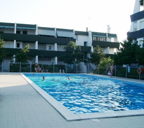 a swimming pool in front of a building at Residence Molo in Lido delle Nazioni