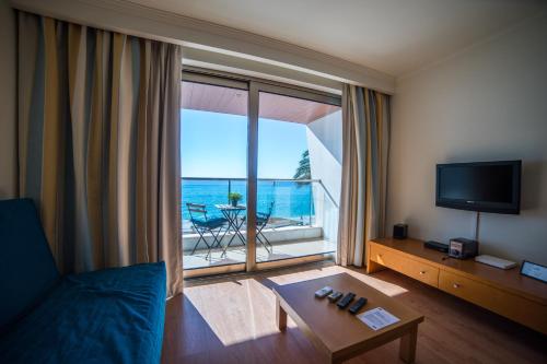 a living room with a view of the ocean at Sezimbra in Sesimbra