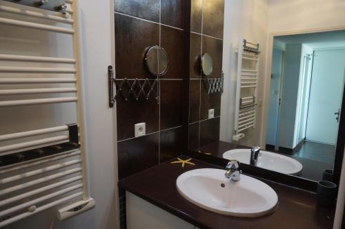 a bathroom with two sinks and a mirror at Port Mezua in Mèze