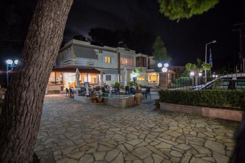 a town square at night with a building at Vasilios Marinos Rooms in Korinthos