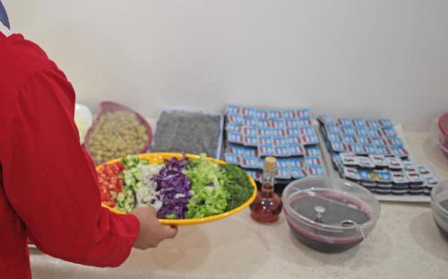 a person holding a bowl of food on a table at Pera City Hotel in Ankara