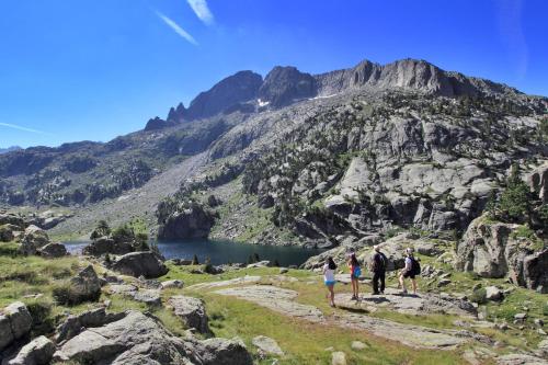 a group of people walking along a mountain trail at Hotel L'Aüt in Erill la Vall