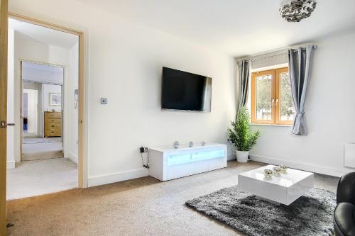a living room with a tv on a wall at The President in Birmingham