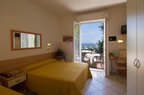 a bedroom with a bed and a view of the ocean at Hotel Des Bains in Cattolica