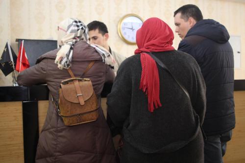 a group of people standing in a room with a clock at Pera City Hotel in Ankara