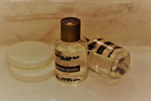 a bottle of soap sitting on a bathroom sink at Pera City Hotel in Ankara