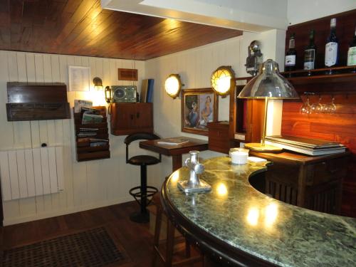 a kitchen with a bar and a counter top at Hôtel Kermor in Concarneau