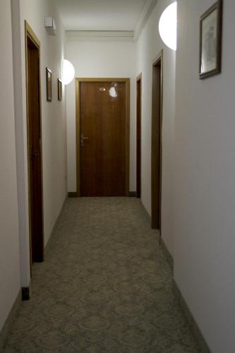 a corridor of a hallway with two doors and a hallwayngth at Hotel Milanese in Rimini
