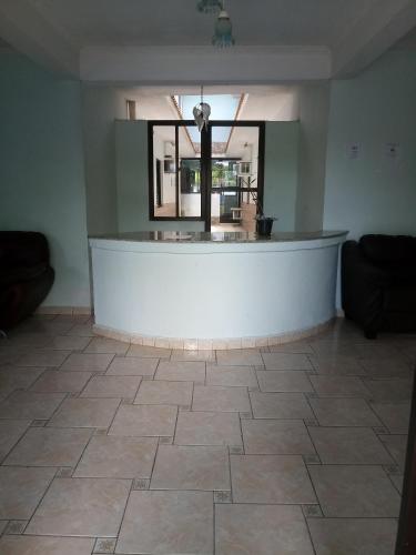 a room with a counter and a tile floor at La Riviera Pousada Pantanal in Itanhaém
