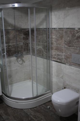 a bathroom with a shower and a toilet at Pera City Hotel in Ankara
