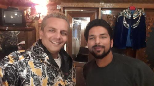 two men standing next to each other in a room at House Boat New Lucifer in Srinagar