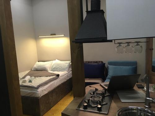 a small room with a bed and a stove at Cozy Home in Old Tbilisi. in Tbilisi City