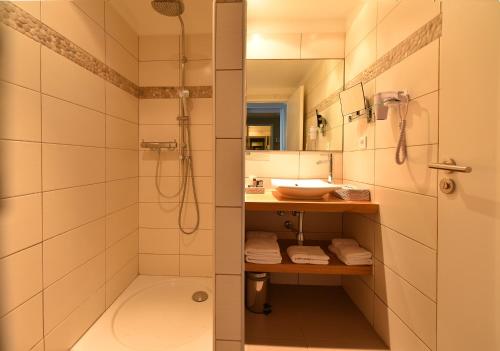 a bathroom with a sink, toilet and shower at Hôtel Abbartello in Olmeto