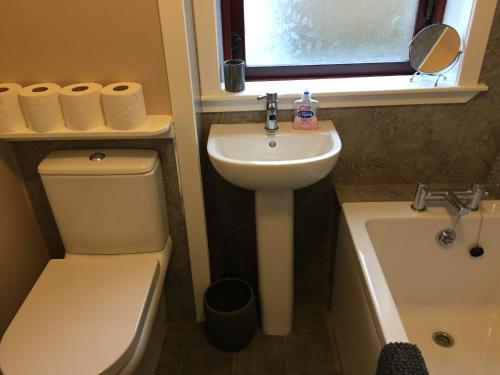 a bathroom with a sink and a toilet and a bath tub at Number 13 in Lerwick