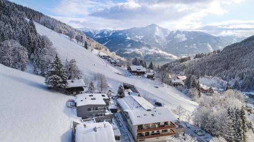 a ski resort in the mountains with snow at Sunny Ferienwohnungen Ski In - Ski Out - Self Check-in in Zell am See