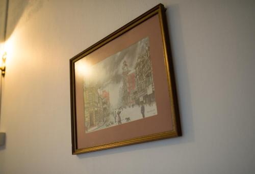 a picture hanging on a wall in a room at SingVillage Holiday House in Mersing
