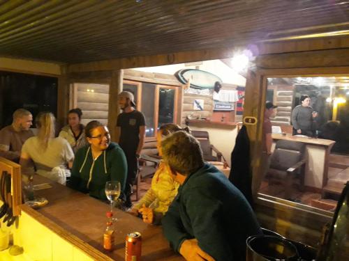 a group of people sitting at a bar at Bella Vista Ranch Ecolodge in Turrialba