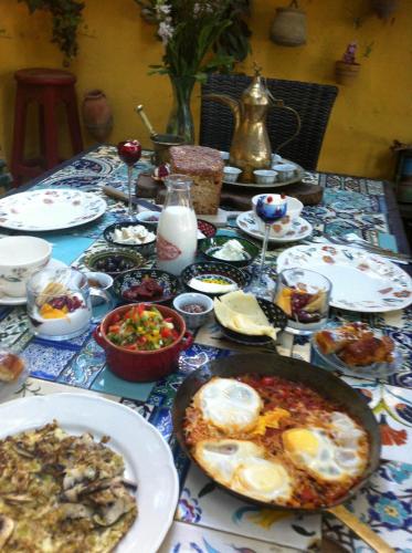 a table with plates of food on a table at Mikes Khan in Abū Ghaush
