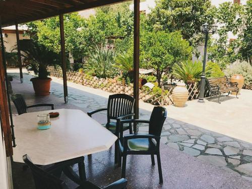 a table and chairs sitting on a patio at Akti Rooms And Studios in Livadion