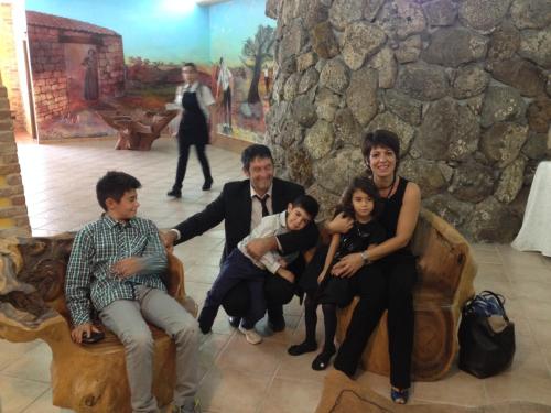 a family posing for a picture in a room at Locanda FarOrientale in Santa Lucia