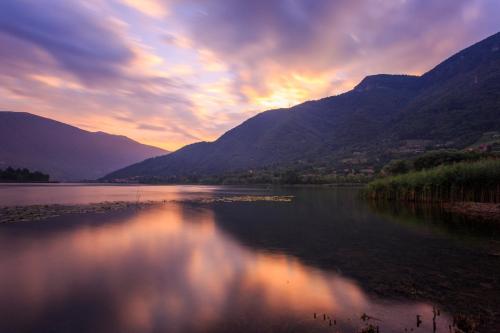 a view of a lake at sunset with mountains at CASA VACANZA Residence Lago di Endine in Monasterolo del Castello
