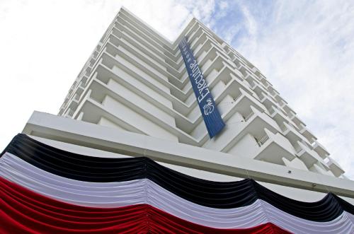 a tall white building with a blue sign on it at The Executive Hotel in Panama City