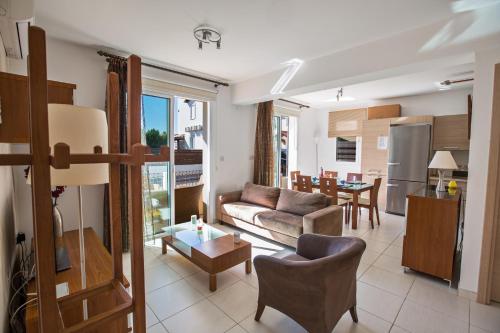 a living room with a couch and a table at Katerina Luxury Villas in Protaras