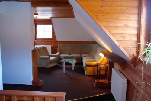 a living room with a couch and chairs at Penzion u Hajneho Bedricha in Harrachov