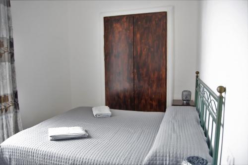 a bedroom with a bed with a wooden door at Aloha House in Formia