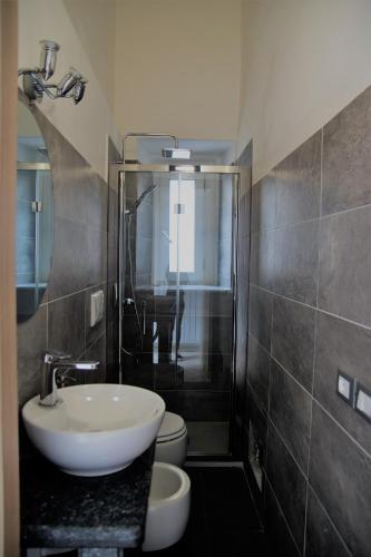 a bathroom with a sink and a toilet at Aloha House in Formia