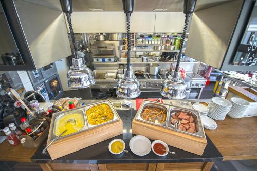 a counter with two trays of food on it at Apartment Hotel Orion in Abertamy