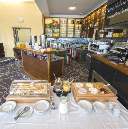 a table with two trays of food on it in a restaurant at Apartment Hotel Orion in Abertamy