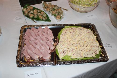 a table with a tray of meat and other foods at Gasthaus Zur Waldesruh in Waffenbrunn