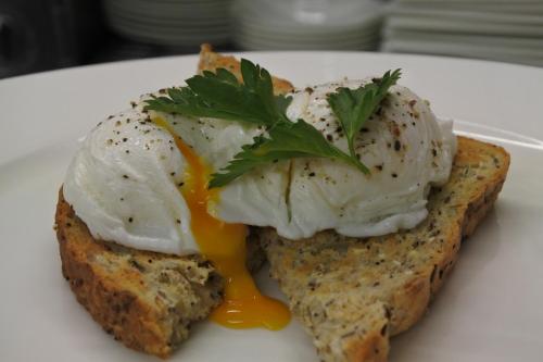 a plate of food with an egg on a piece of bread at Magpies Restaurant with Rooms in Horncastle
