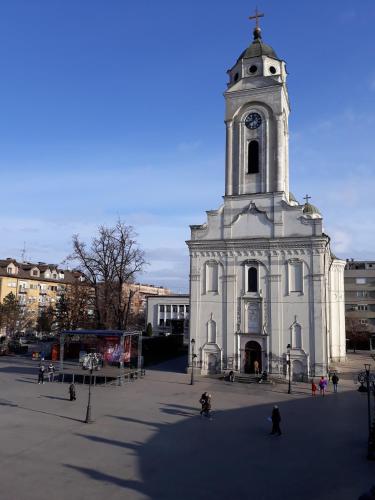 a large white church with a clock tower at Prenociste Nikolas Grand in Smederevo