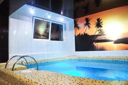a swimming pool in a room with a painting at Central Hotel in Soroca