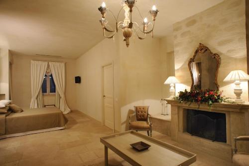 a living room with a bed and a fireplace at Castello Camemi in Vizzini