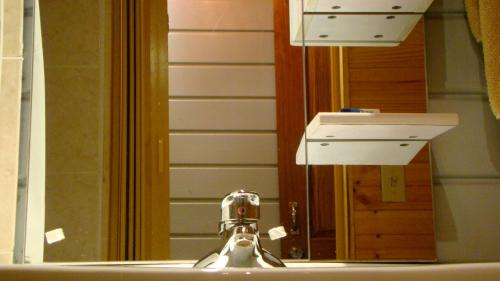 a bathroom sink with a faucet and a mirror at Hotel Laguna in Bocas Town