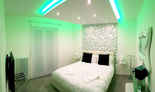 a bedroom with a large white bed with blue lights at Diamond Suite Verona in Verona