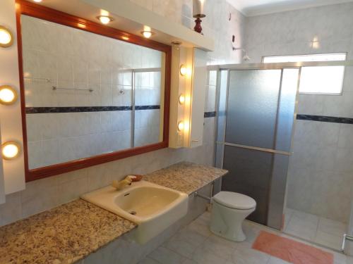 ein Bad mit einem Waschbecken, einer Dusche und einem WC in der Unterkunft Casa Tacumsol in Fama