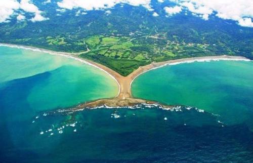 an aerial view of an island in the water at Tropical Beach in Uvita