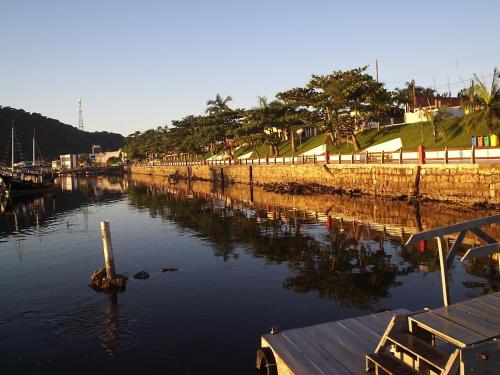 a body of water with a dock in the water at Hotel Recanto do Sol in Cananéia
