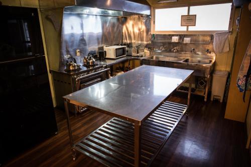 a kitchen with a table in the middle of it at Annupuri Oasis Lodge in Kutchan