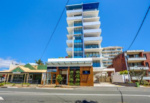 a building on a street in front of a building at Direct Collective - Sea Breeze Mooloolaba in Mooloolaba