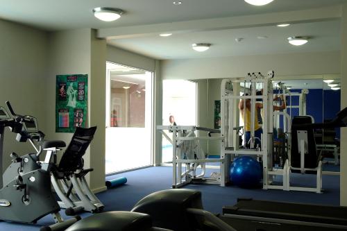 a gym with machines and a person in the mirror at Mantra Lorne in Lorne