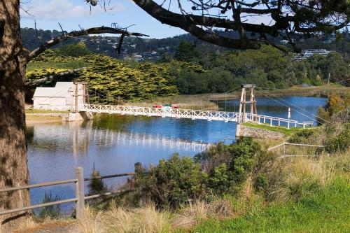 a white bridge over a river with a fence at Mantra Lorne in Lorne
