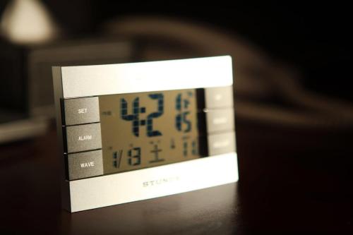 a clock sitting on top of a table at Toho Hotel in Osaka