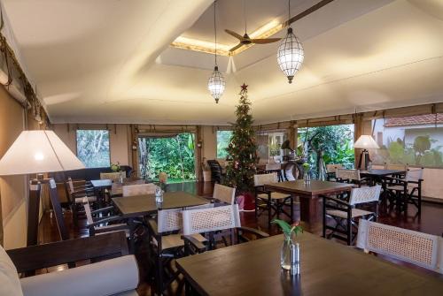 an empty restaurant with tables and chairs and lights at Sebatu Sanctuary Eco-resort in Tegalalang
