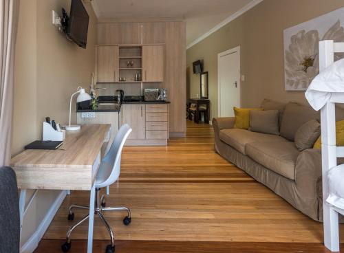 a living room with a couch and a table at A&A Guesthouse in Port Elizabeth